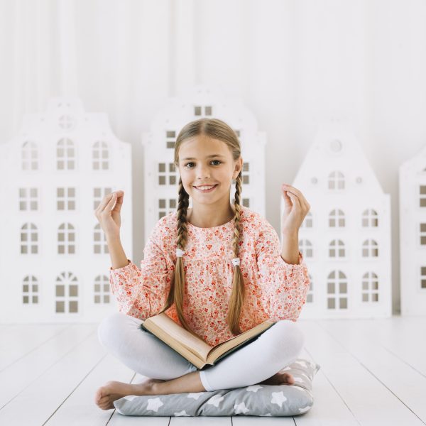 lovely-happy-girl-posing-with-book